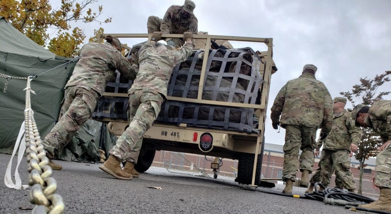 Soldiers from the 89th Military Police Brigade secure their equipment after loading it on a trailer at Fort Knox, Ky in preparation of a possible mission to support federal, state and local law enforcement agencies along the southwest border.