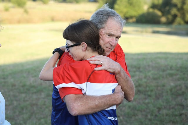 President George W. Bush hugs a biker