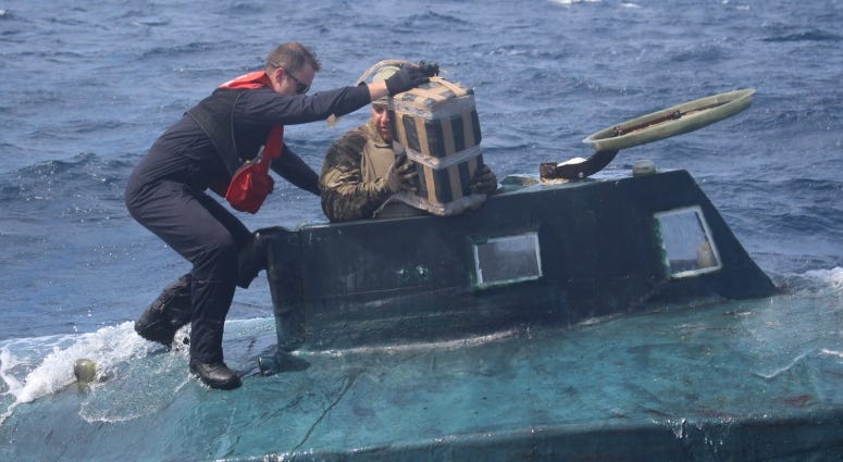 U.S. Coast Guard boarding team members climb aboard a suspected smuggling vessel in September. Crews intercepted a drug-laden, 40-foot self-propelled semi-submersible (SPSS) in the Eastern Pacific. U.S. Coast Guard boarding team members climb aboard a suspected smuggling vessel.