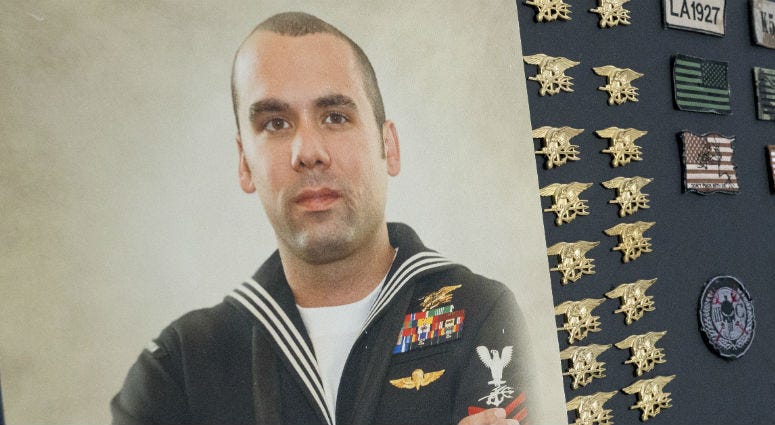 In his parents home a photo of Ryan Larkin, a decorated Navy SEAL who committed suicide after suffering from undiagnosed Traumatic Brain Injury, is displayed next to the SEAL Tridents left by comrades on his casket In his parents home a photo of Ryan Larkin, a decorated Navy SEAL who committed suicide after suffering from undiagnosed Traumatic Brain Injury, is displayed next to the SEAL Tridents left by comrades on his casket