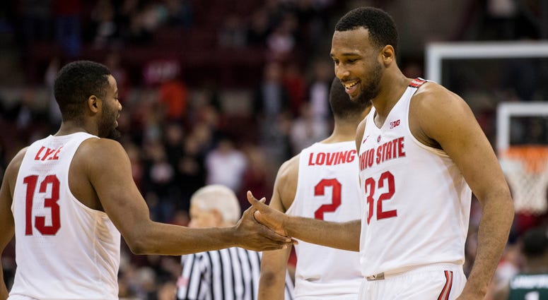 Ohio State Buckeyes center Trevor Thompson (32) and guard JaQuan Lyle (13) share a handshake near the end of the game against the Michigan State Spartans at Value City Arena.