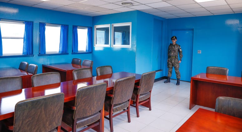 A South Korean solider stands on guard in a conference room at the border village of Panmunjom in the demilitarized zone (DMZ) on April 18, 2018.
