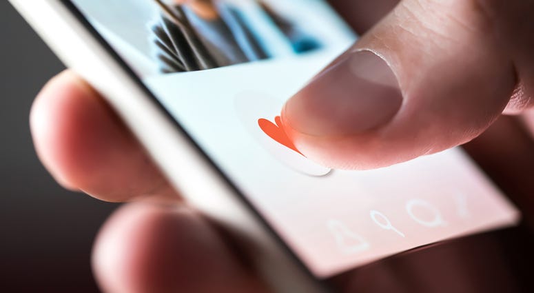 Man giving a like to photo on social media or swiping on online dating app. GrindrOnlineDatingApp