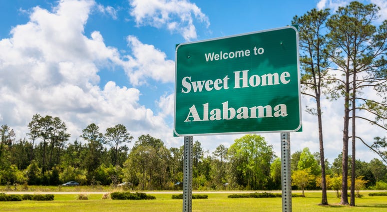 Welcome to Sweet Home Alabama Road Sign along Interstate 10 in Robertsdale, Alabama USA, near the State Border with Florida.