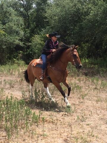 Mary Ballangee riding her horse.