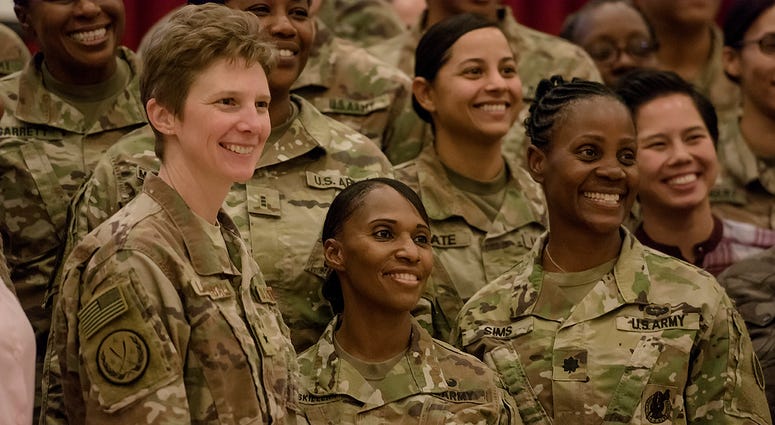 U.S. Air Force Brig. Gen. Leah Lauderback, Col. Carmelia Scott-Skillern and Lt. Col. Donna Sims pose for a photo with other attendees during a Sisters in Arms forum Oct. 25, 2017, at the Zone 1 Chapel.