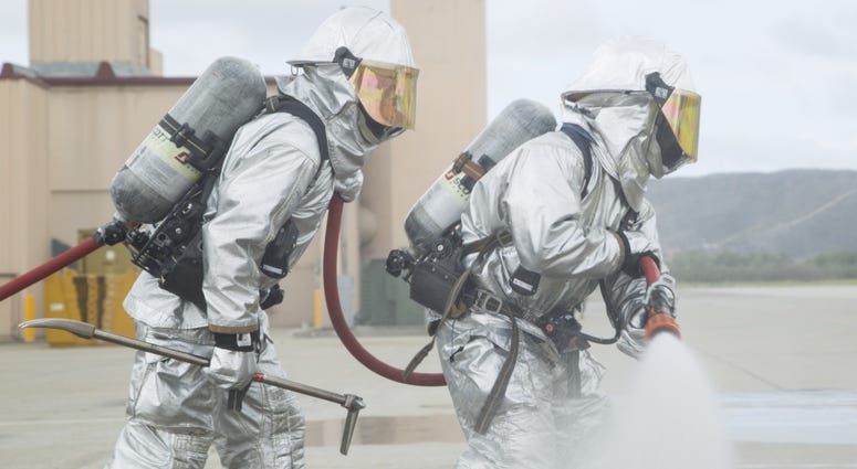 U.S. Marine Corps Lance Cpl. Robert Brewer, 20, an expeditionary firefighting and rescue specialist, puts out a simulated fire using a handline so firefighters can retrieve injured personnel during a routine training exercise on Camp Pendleton, Calif.
