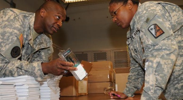 Sgt. Maj. Michel Pigford, the senior enlisted adviser for Performance Triad, describes the Fitbit bracelet to Master Sgt. Sandra Meyers, personnel services NCOIC, 82nd Sustainment Brigade, Sept. 25, at Fort Bragg, N.C. Meyers is part of a group deploying fitbit