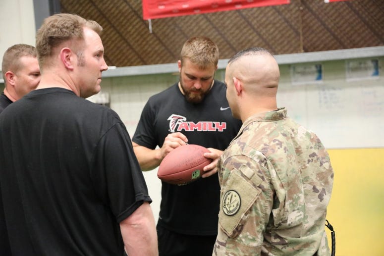 Atlanta Falcons Offensive Lineman, Ben Garland, signs footballs for Combined Joint Task Force – Operation Inherent Resolve members in the gym on Union III in Baghdad, Iraq, June 17, 2018.