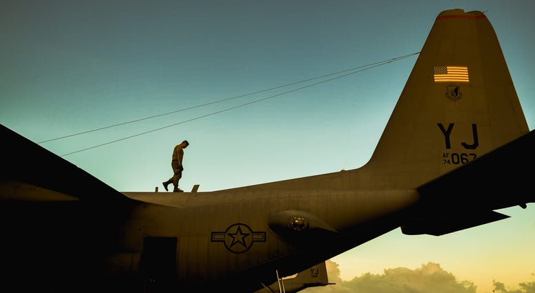 An Airman from the 374th Maintenance Squadron checks a C-130 Hercules for potential damage during Operation Christmas Drop 2016 at Andersen Air Force Base, Guam, Dec. 6, 2016.