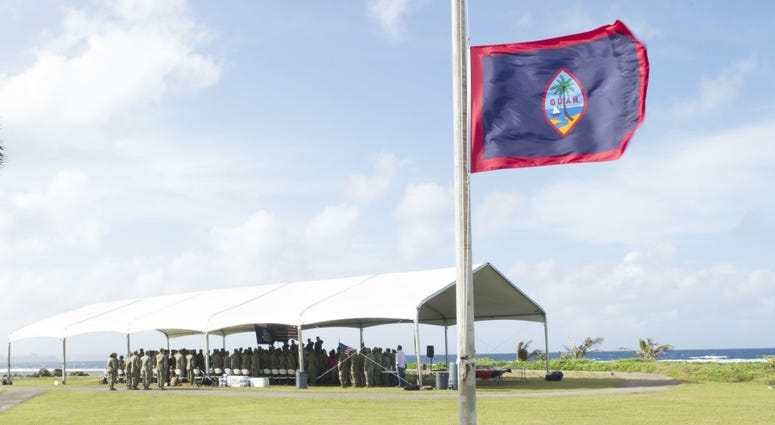 SANTA RITA, Guam, (Dec 19, 2018) Attendees of the Coastal Riverine Group (CRG) 1, Det. Guam change of charge ceremony stand during the presentation of the colors, singing of the national anthem and Guam hymn at Asan Beach War Memorial.