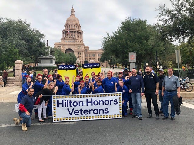 Veterans employed by Hilton take part in a parade in Austin, TX.