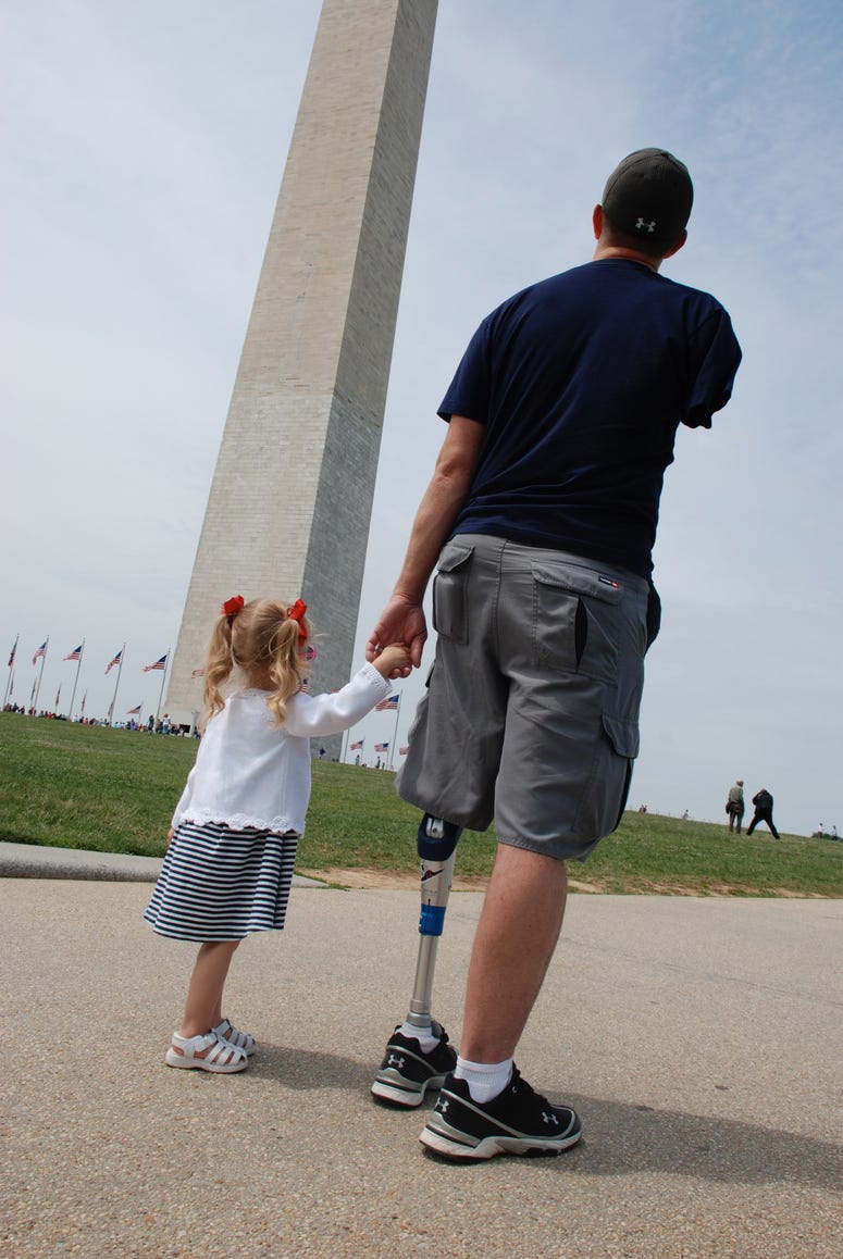 Retired Army Capt. Ryan Kules and one of his daughters at the Washington Memorial in Washington, D.C. Kules