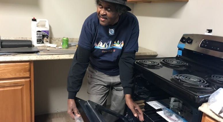 John Greene, a 75-year old U.S. Army veteran, shows off his new stove in his newly renovated home. John Greene
