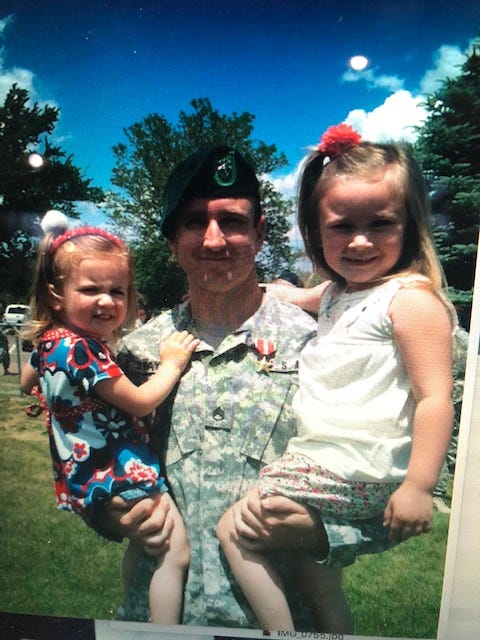 Army Sgt. First Class Rich Stayskal with his two daughters.