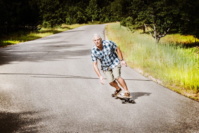 Mike Maloney says gliding on a longboard reminds him of his time flying fighter jets for the Navy KOTA longboards founder Navy veteran Mike Maloney on one of his boards