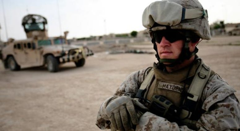 Sgt. Douglas Hayden, st Battalion, 2nd Marine Regiment, waits outside of an Iraqi police station Hayden, 32, from Fancy Farm, Ky., was a part of the initial invasion of Iraq and now is part of the transition phase. marine
