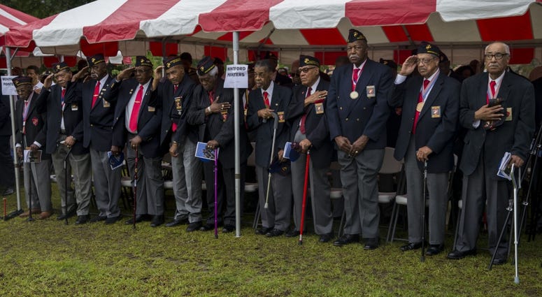 Montford Point Marines salute the colors during the Montford Point Marine Memorial gifting ceremony at the Montford Point Marine Memorial in Jacksonville, N.C., July 25, 2018.