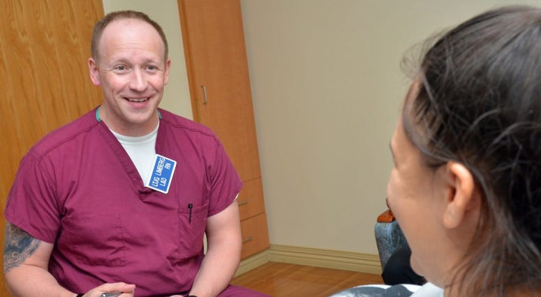 JACKSONVILLE, Fla. (March 29, 2018) Lt. j.g. Wesley Limberg, a registered nurse at Naval Hospital Jacksonville’s Labor and Delivery unit, asks Carolina Wilson questions about her pregnancy.