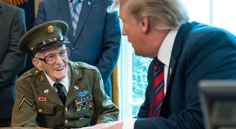 U.S. President Donald Trump greets WWII veterans in the Oval Office of the White House April 11, 2019 in Washington, DC