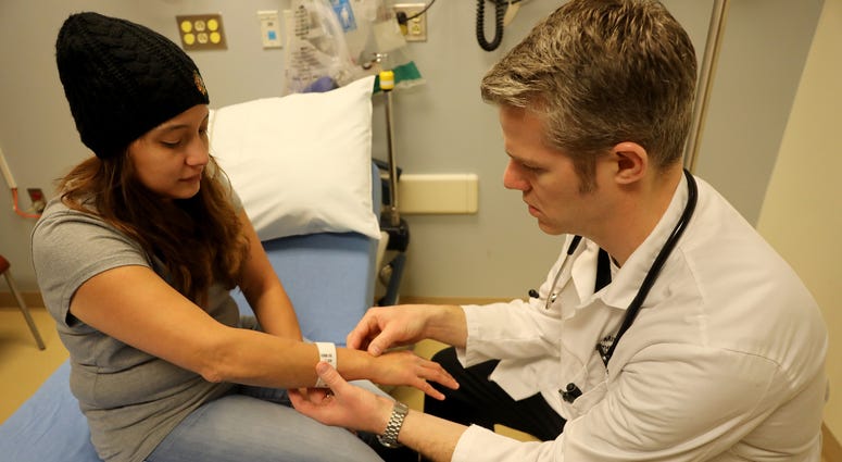 Dr. Mark Livak talks over pain medication options while examining patient Zulidany Cortez on Jan. 19, 2018 at Amita Health Adventist Medical Center in Bolingbrook, Ill. opioid