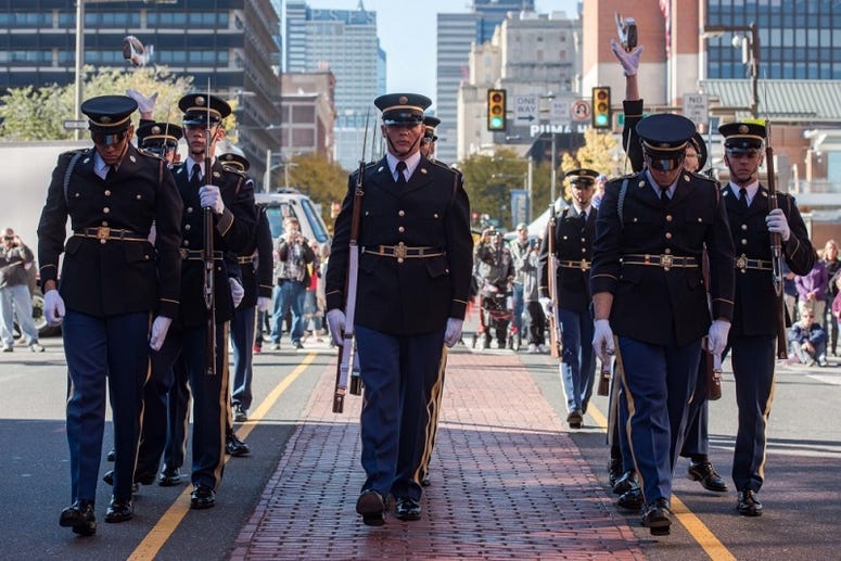 Soldiers assigned to the U.S. Army Drill Team, 4th Battalion, 3d U.S. Infantry Regiment (The Old Guard) complete the front to back rifle toss during a performance in Philadelphia, Pennsylvania, November 4, 2018.