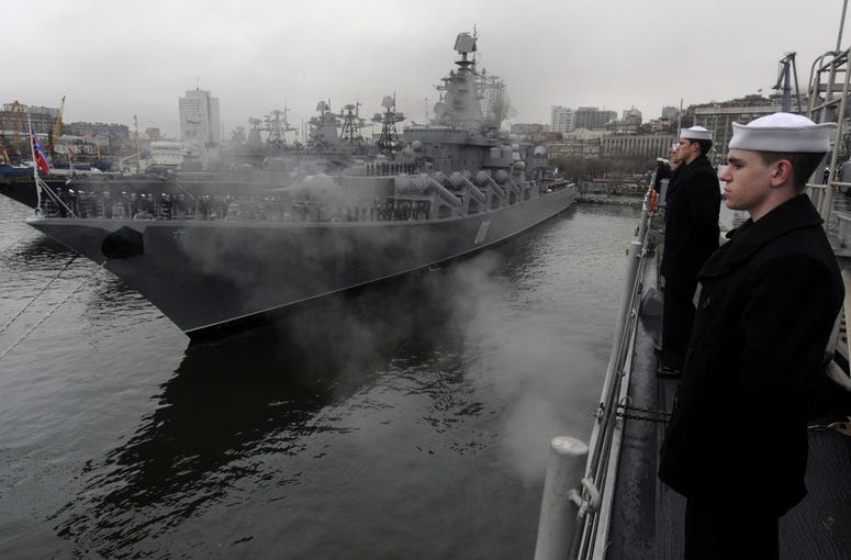 Fireman Nathan Kander, machinist's mate, mans the rails aboard the U.S. 7th Fleet command ship USS Blue Ridge as the ship pulls into Vladivostok, Russia.
