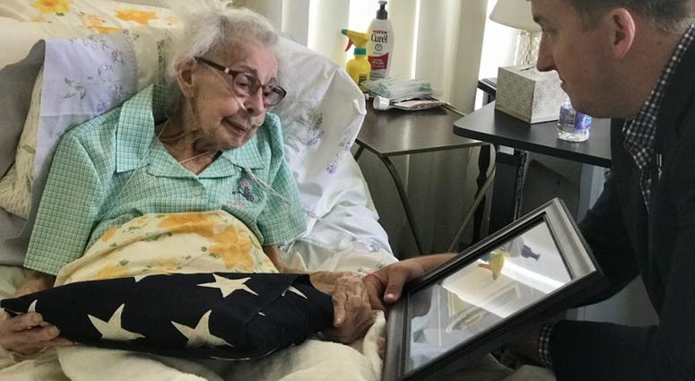 Purple Hearts Reunited founder Zach Fike returns a medal to the widow of the vet who received it.