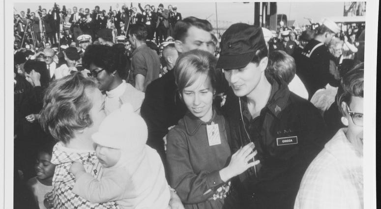 Sergeant Robert J. Chicca, U.S. Marine Corps, a USS Pueblo (AGER-2) crewman, greets his wife, Ann Marie, on his arrival at Naval Air Station Miramar, California, 24 December 1968. Pueblo's crew had been released from captivity by the North Korean governme Pueblo Crew