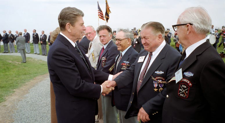 President Reagan with former U.S. Rangers at Pointe du Hoc, Normandy, France on June 6th, 1944. President Ronald Reagan with veterans of D-Day on June 6, 1984