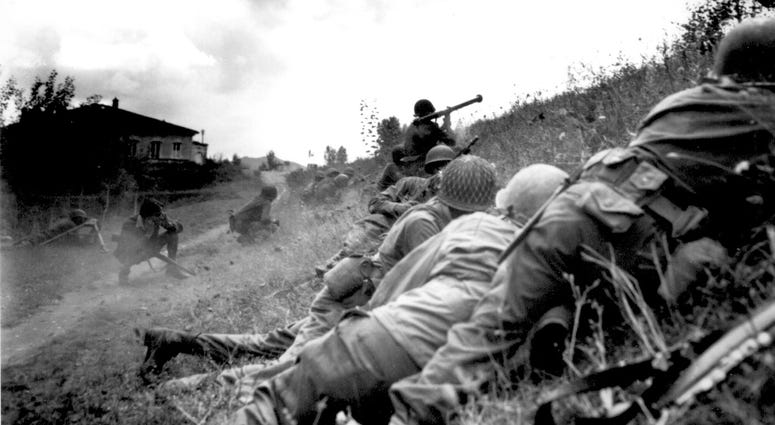 12. This Negro combat patrol advanced three miles north of Lucca (furthermost point occupied by American troops) to contact an enemy machine gun nest. Here a bazooka-man cuts loose at the target some 300 yards distant. September 7, 1944