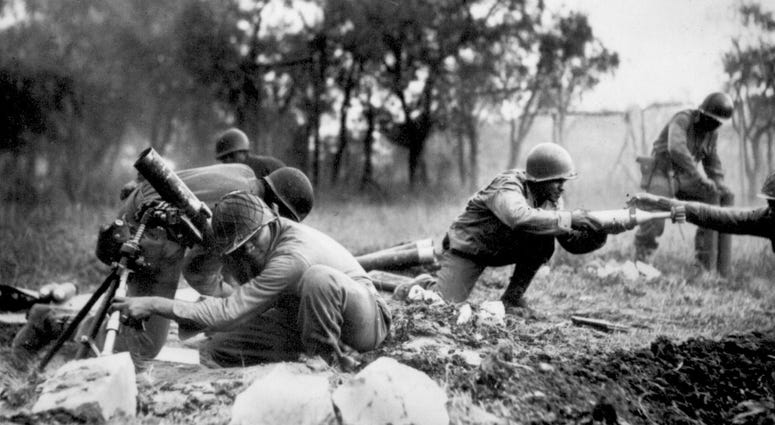 13. Members of a Negro mortar company of the 92nd Division pass the ammunition and heave it over at the Germans in an almost endless stream near Massa, Italy. This company is credited with liquidating several machine gun nests.