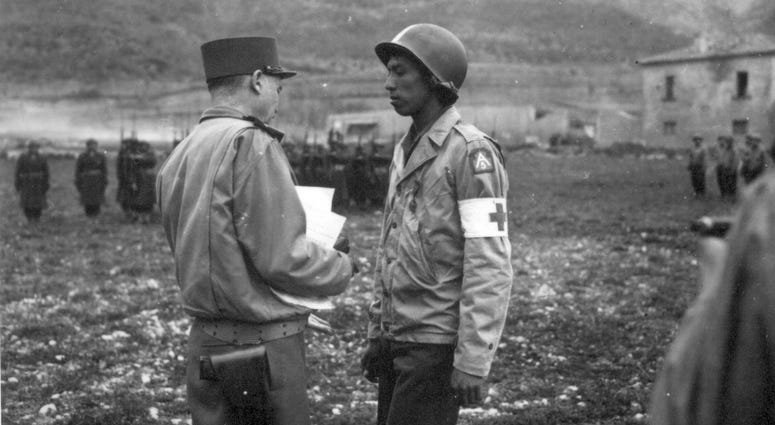 8. Pvt. Jonathan Hoag, of a chemical battalion, is awarded the Croix de Guerre by General Alphonse Juin, Commanding General of the F.E.C., for courage shown in treating wounded, even though he was wounded. Pozzuoli area, Italy. March 21, 1944
