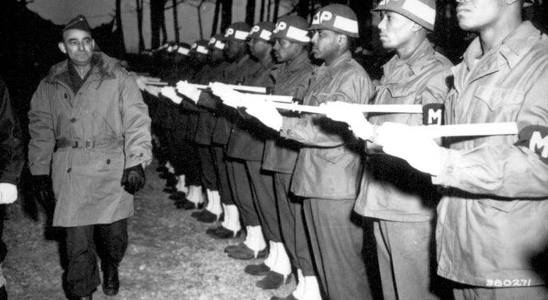 9. Lt. Gen. Joseph T. McNarney, Deputy Supreme Allied Commander, Mediterranean Theater, inspects Honor Guard of MPs during his tour of the Fifth Army front at the 92nd Division Sector. January 4, 1945.