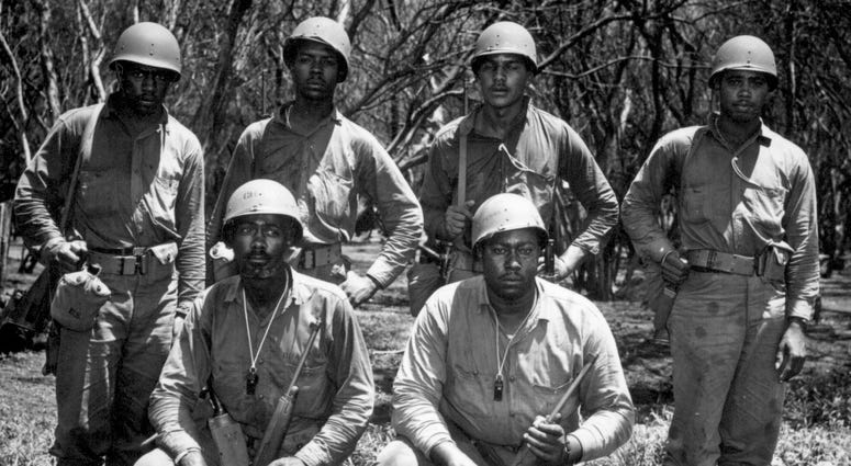 This company is undergoing combat training by Service Force Advance Base Section at a station on Oahu Island prior to their departure for duty in a combat area. Left to right, front row: Boatswain Mate Second Class James W. Chase and Coxswain John D. Perry. Left to right, back row: Coxswains Raymond C. Vaultz, Elmer Williams, Darrel M. Beech, and Jimmie Cook