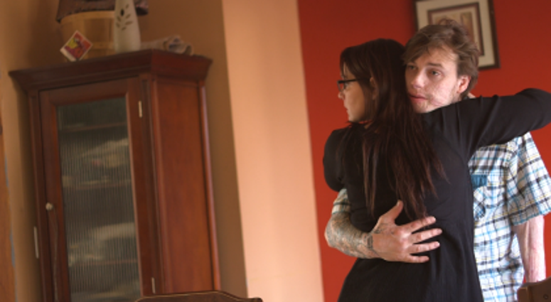 Caregiver Kelly Stephenson hugs her husband U.S. Army Staff Sgt. Scott Stephenson, (Ret.). Their lives were documented in the new film, "The Weight of Honor." Weight of Honor