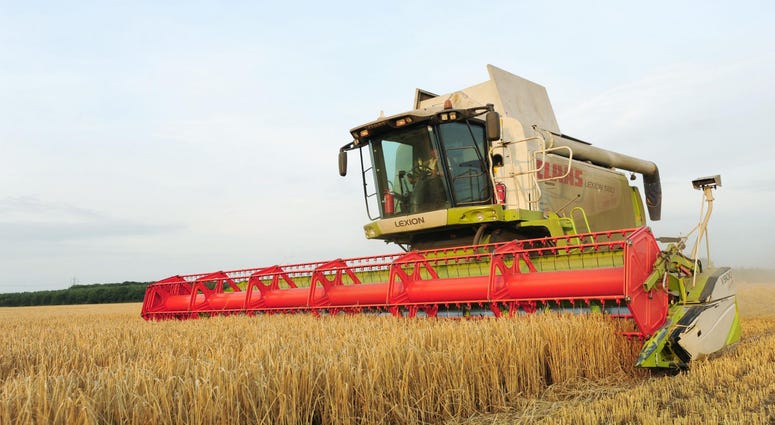 File photo dated 20/08/13 of a combine harvester at work in a field.