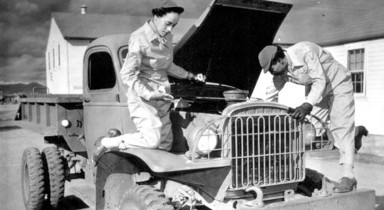 Auxiliaries Ruth Wade and Lucille Mayo (left to right) further demonstrate their ability to service trucks as taught them during the processing period at Fort Des Moines and put into practice at Fort Huachuca, Arizona. December 8, 1942