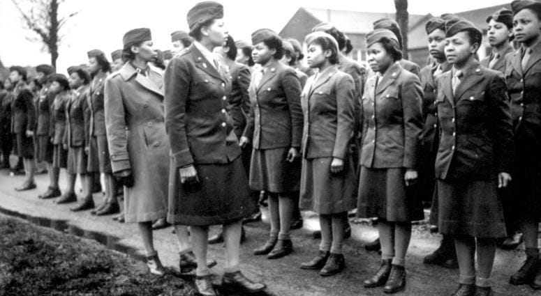 Somewhere in England, Maj. Charity E. Adams, and Capt. Abbie N. Campbell, inspect the first contingent of Negro members of the Women's Army Corps assigned to overseas service. February 15, 1945