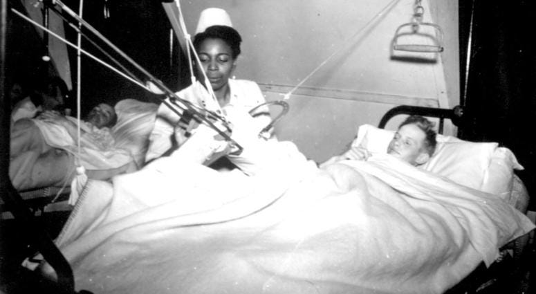 Lt. Florie E. Gant...tends a patient at a prisoner-of war hospital somewhere in England. October 7, 1944