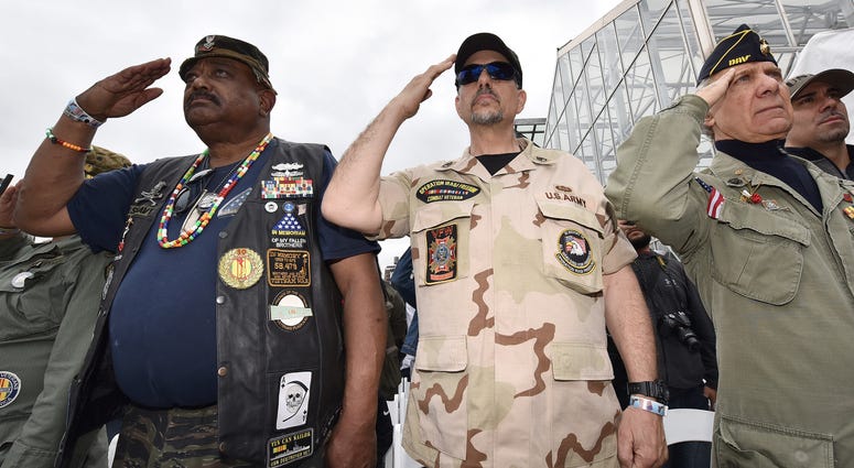 United States Armed Forces veterans salute during the playing of "Echo Taps" during the annual Memorial Day ceremony at the Intrepid Sea, Air & Space Museum at Pier 86 in New York, NY, on May 28, 2018.
