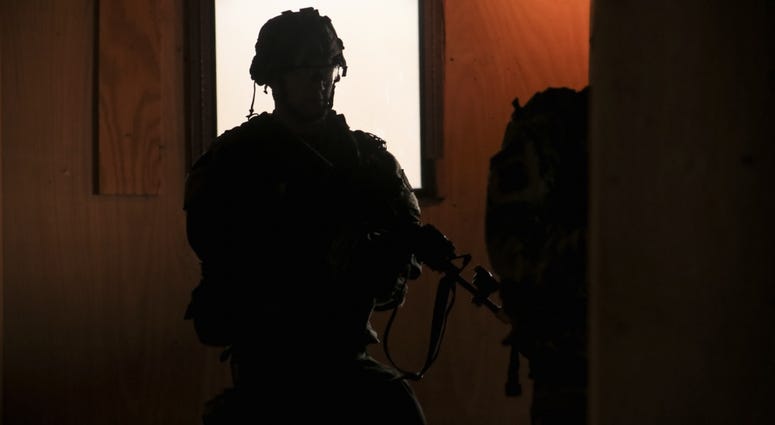 A U.S. Soldier, assigned to 1st Brigade, 25th Infantry Division, patrols the halls of a recently captured building, during Decisive Action Rotation 17-03 at the National Training Center in Fort Irwin, Calif., Jan 13, 2017. ntc