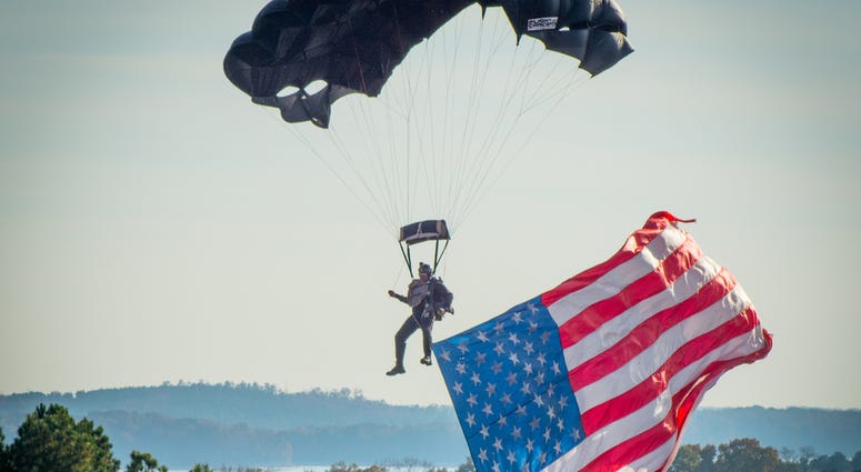 A U.S. Army Special Forces Soldier flies into Clemson University's Memorial Stadium. Nat Guard can get free tuition in SC and other benefits.