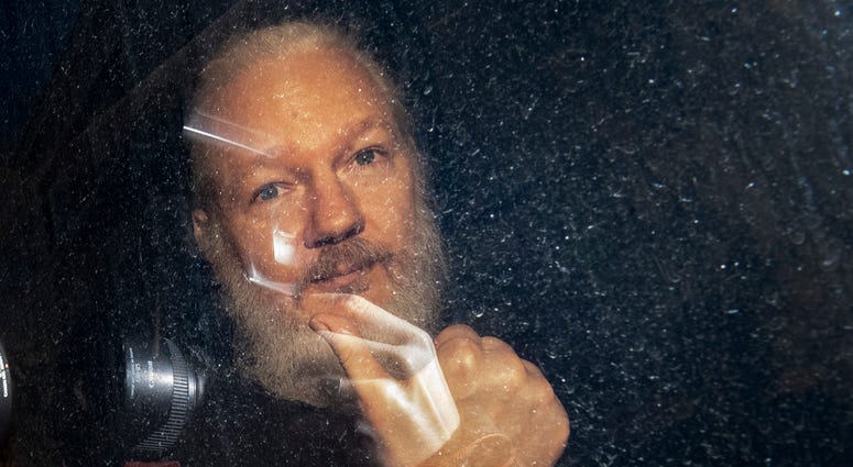 Julian Assange arrives at Westminster Magistrates' Court in London, after the WikiLeaks founder was arrested by officers from the Metropolitan Police and taken into custody following the Ecuadorian government's withdrawal of asylum.