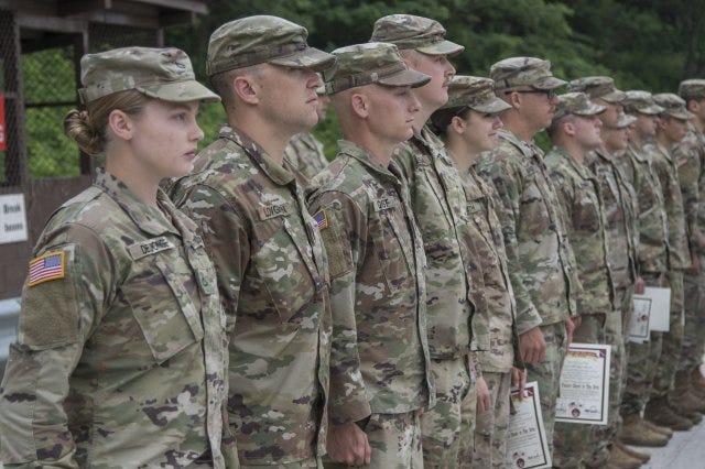 Nebraska National Guard Soldiers with the 1-134th Cavalry Squadron receive certificates and silver spurs after successful completion of a spur ride during annual training in the Republic of Korea. Nebraska National Guard Soldiers with the 1-134th Cavalry Squadron receive certificates and silver spurs after successful completion of a spur ride during annual training in the Republic of Korea.