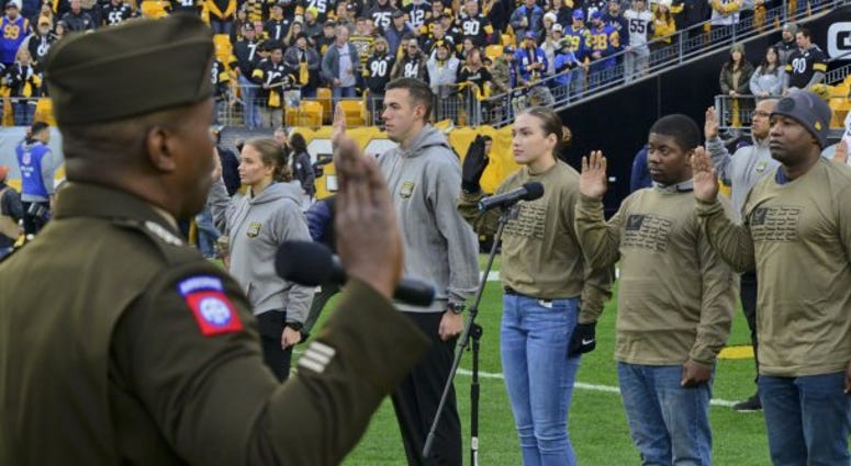 Lt. Gen. Bruce Crawford, the Army's chief information officer, administers the oath of enlistment
