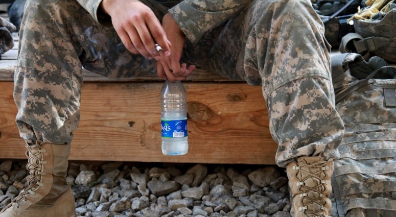 U.S. Army Spc. William Lang, 25, from Dallas, Texas, assigned to the Kapisa-Parwan Provincial Reconstruction Team, smokes a cigarette while waiting to go out on mission from Bagram Airfield, Afghanistan on Aug. 9.