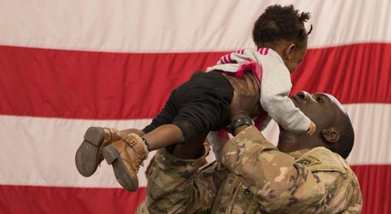 A soldier reunites with his daughter at Fort Bragg, N.C. after returning from the Middle East.