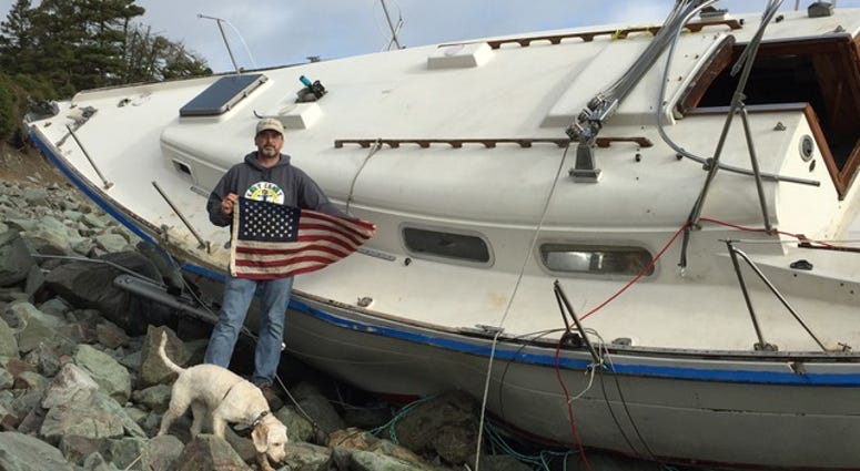 Retired Sailor Steve Smith with an American flag recovered from the shipwrecked Liberty