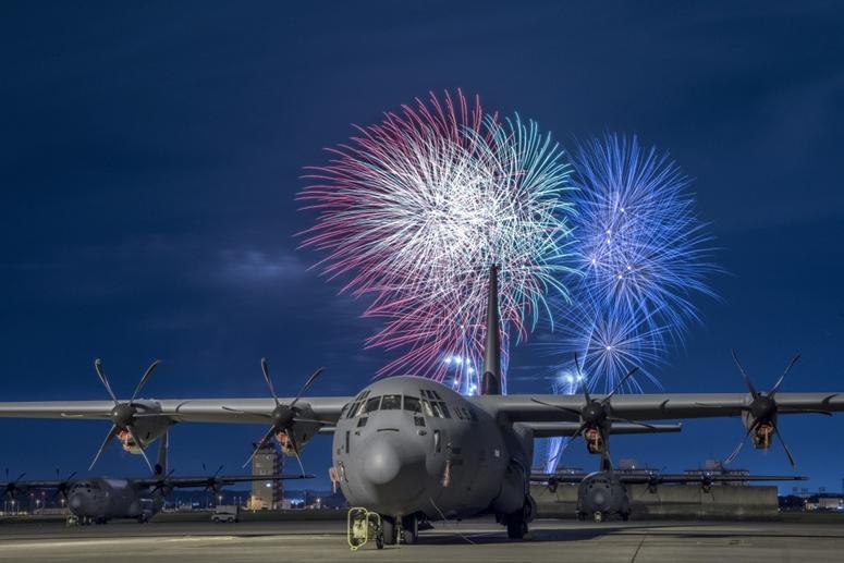 A C-130J Super Hercules rests on the flightline under a fireworks display, July 3, 2018, at Yokota Air Base, Japan. Fireworks